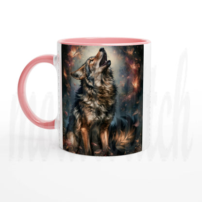 A ceramic mug with a pink handle and pink interior, featuring a printed graphic of a howling wolf against a dark, fiery background.