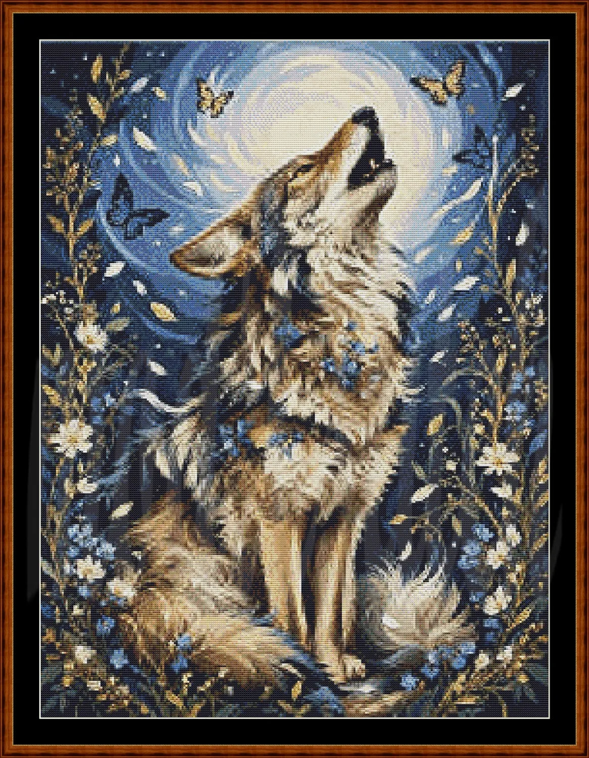 A framed needlepoint or cross-stitch style artwork showing a howling wolf centered against a swirling blue and white moonlit background, surrounded by butterflies, flowers, and foliage, with a brown wooden frame.