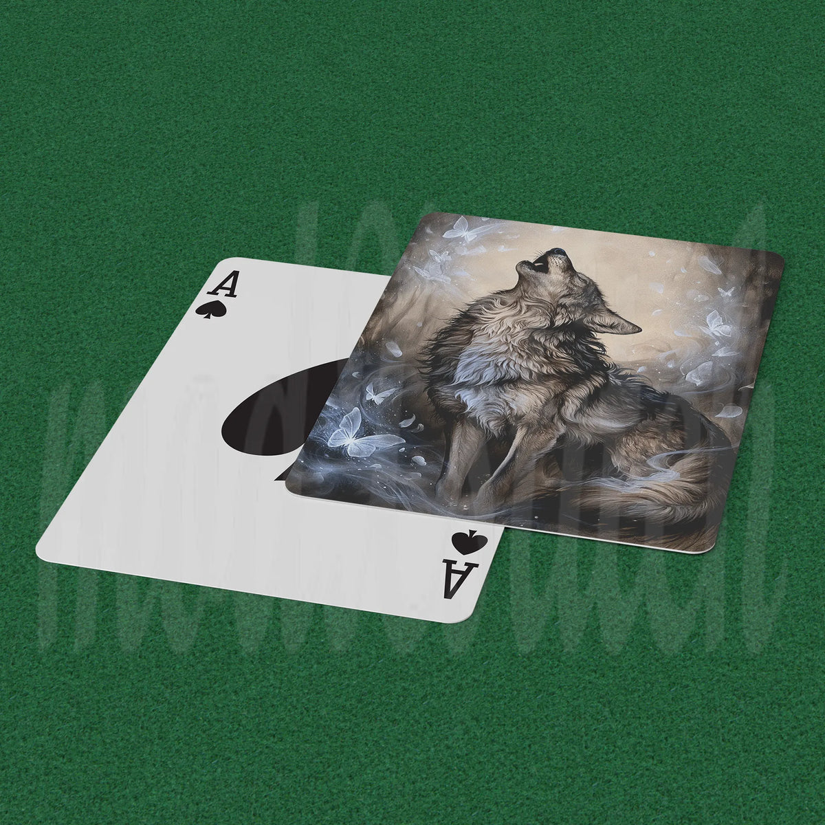 A custom playing card featuring an artistic illustration of a howling wolf amidst smoke, shown partially slid off a standard white Ace of Spades card on a green felt surface.